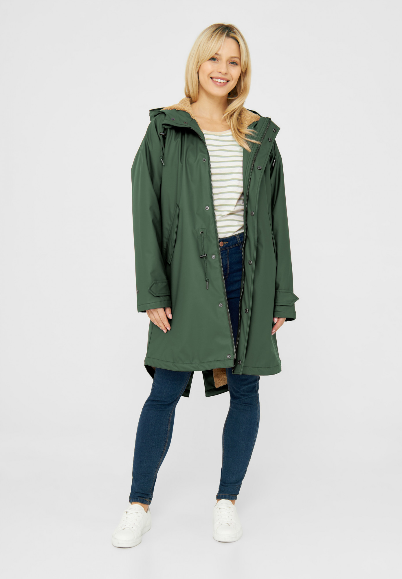 Weibliches Model trägt eine grünen Regenjacke Damen von derbe