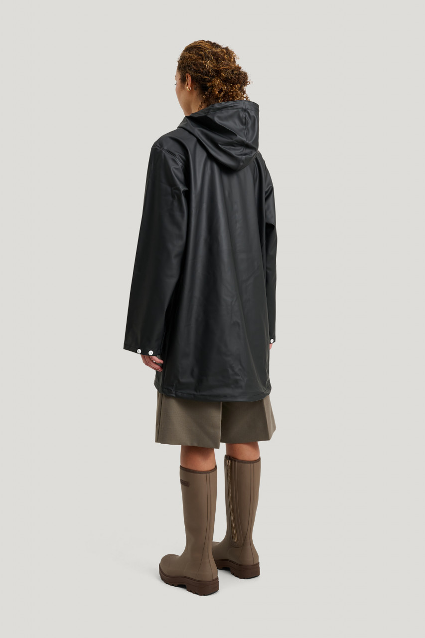 Frau trägt schwarze Regenjacke - Rückansicht - 7